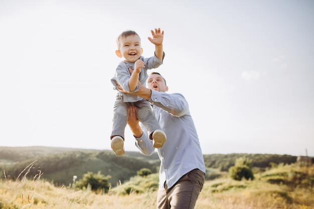 Father's day. Dad and son playing together outdoors on summer.