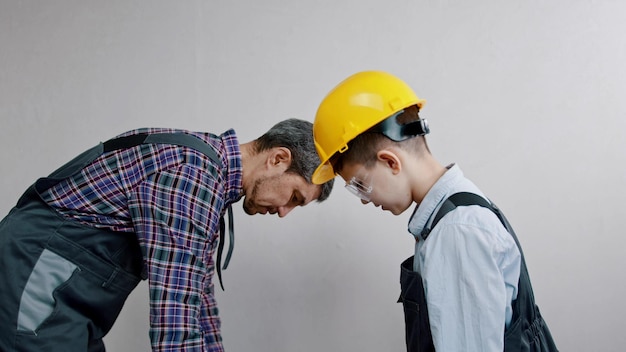 Father and son about to paint the wall