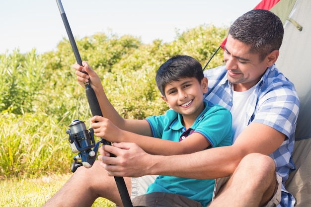 Father and son beside tent