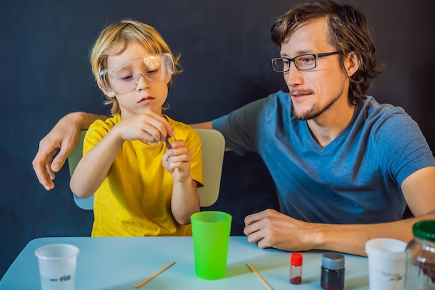 Father and son conduct chemical experiments at home home made slime