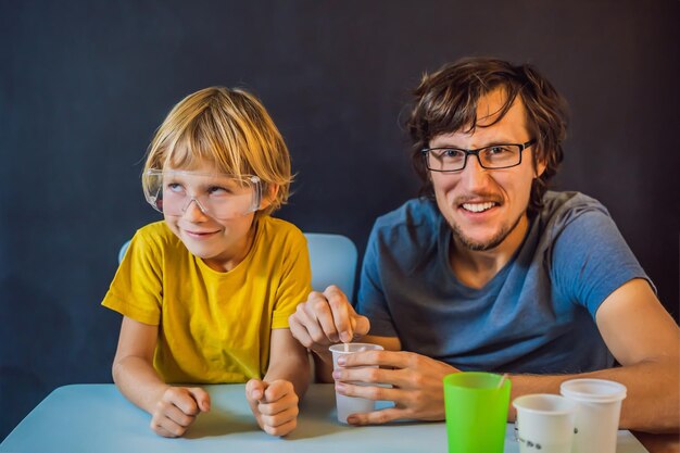 Father and son conduct chemical experiments at home Home made slime