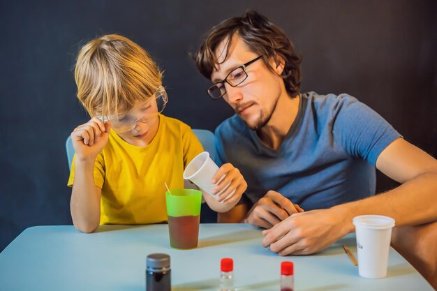 Father and son conduct chemical experiments at home Home made slime