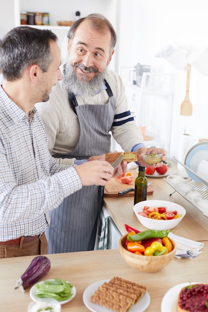 Father and son cooking in the kitchen