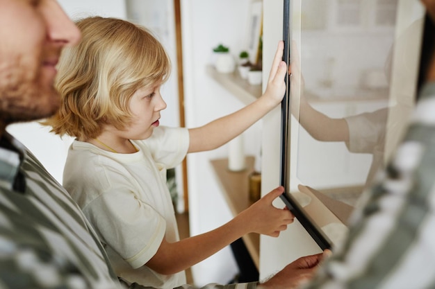 Father and Son Hanging Picture Together