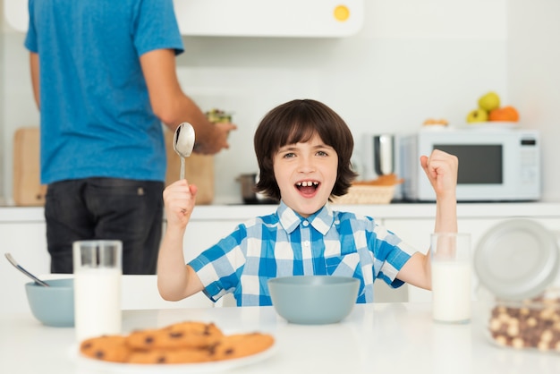 Father and son have breakfast in the light kitchen