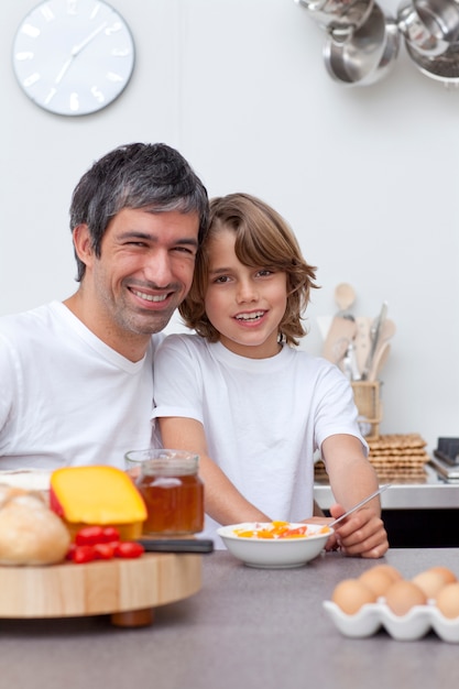 Father and son having breakfast together