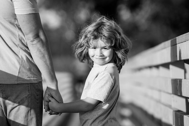 Father and son holding hand in hand weekend activity happy family lifestyle concept