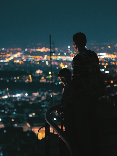 Father and son looking at the night city.