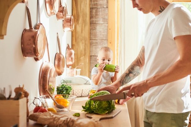 Father and son making lunch in the kitchen