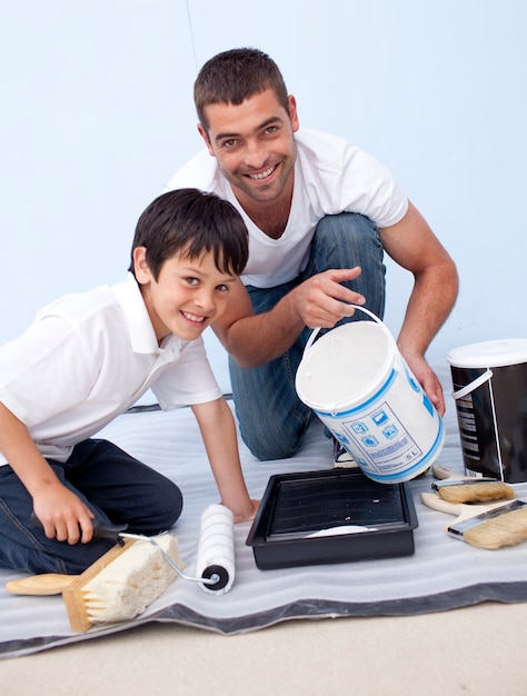 Father and son painting a room