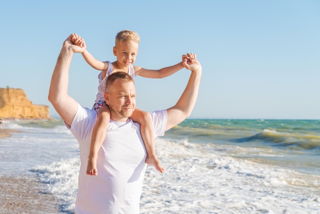 Father and son playing on the beach.