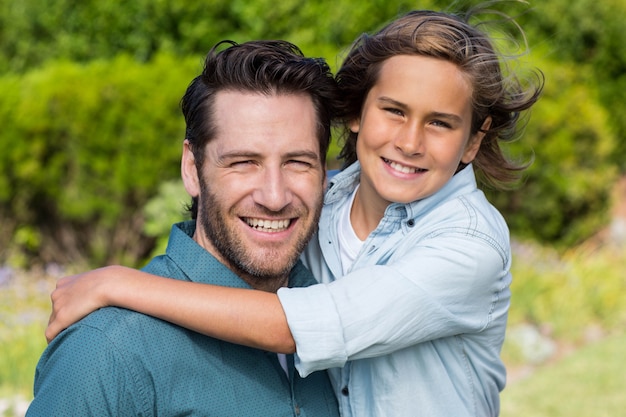 Father and son smiling at camera