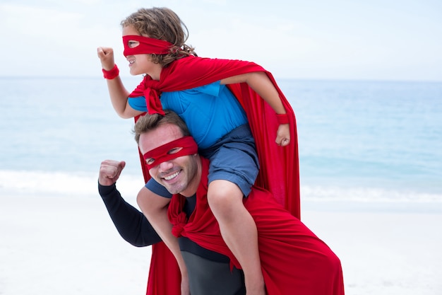 Father and son in superhero costume pretending to run