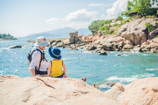 Father and son travelers at the Hon Chong cape, Garden stone, popular tourist destinations at Nha Trang. Vietnam