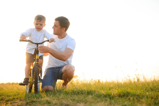 Father teaching his son how to ride a bicycle