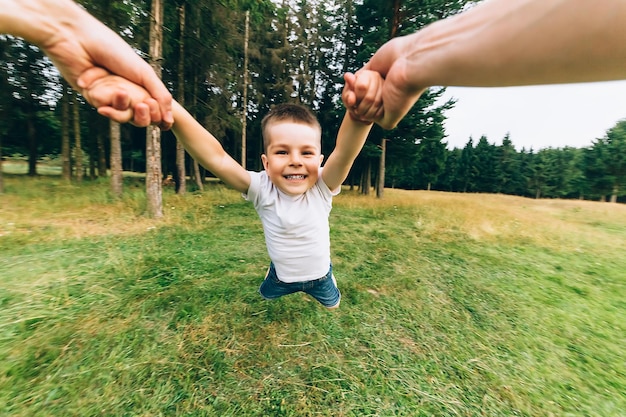 Father throwing his little son up in the air family time together happy little boy having fun with h