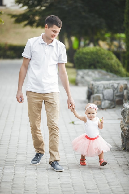 father walking with his little child outdoors