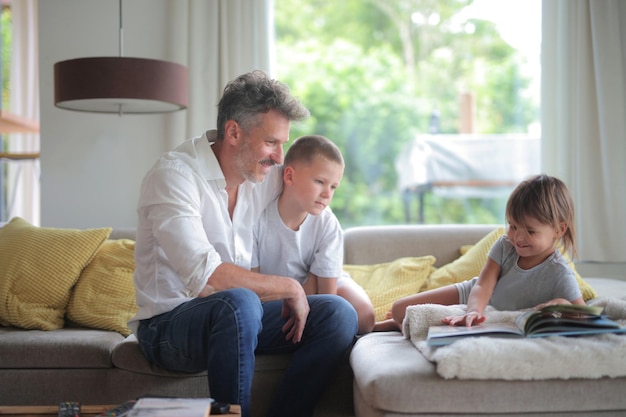 father with his children on the sofa at home