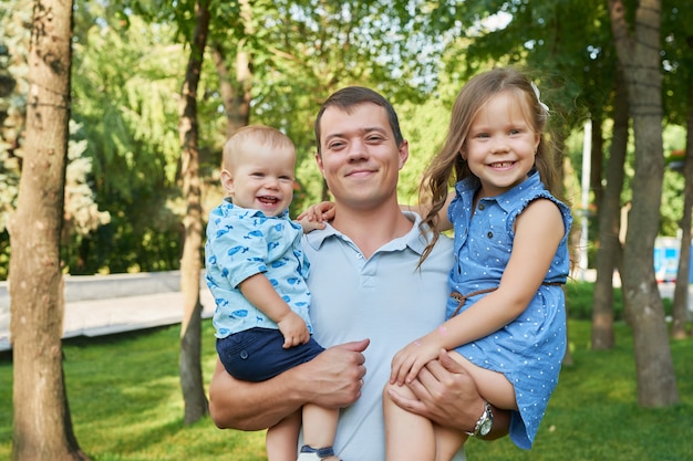 father with his daughter and son in a park