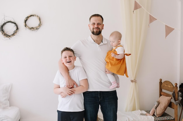 Father with his son and daughter at home Happy family having fun together Happy Father39s Day