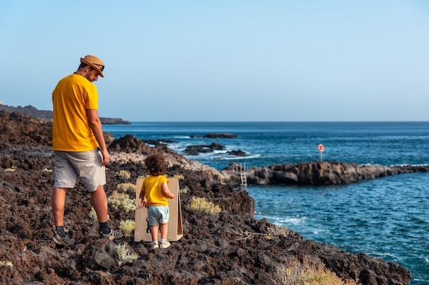 A father with his son walking on the beach of Tacoron on El Hierro Canary Islands