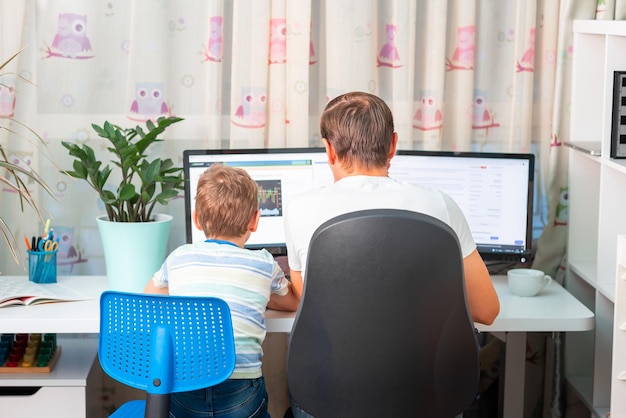 Father with kid trying to work from home during quarantine Stay at home work from home concept during coronavirus