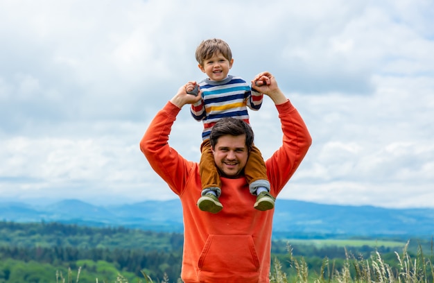 Father with son walking at outdoor with mountains