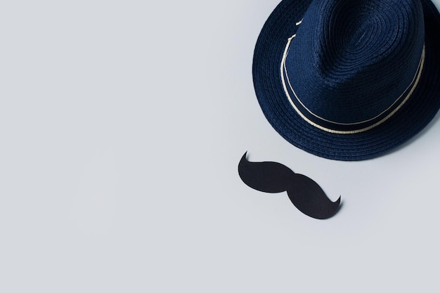 Fathers day concept with hat and mustache on blue background