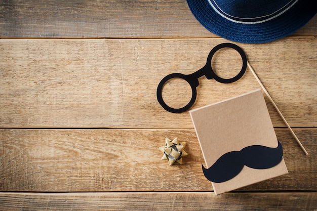 Fathers day concept with mustache and over male accessories on wooden background