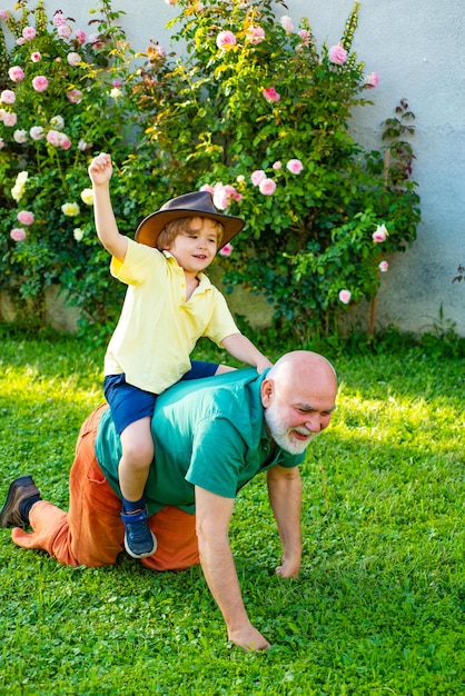 Fathers day Happy child with Grandfather playing outdoors Fathers day Two different generations ages