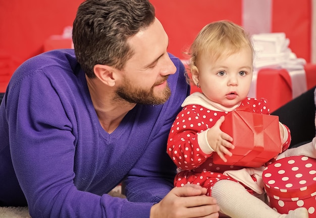 Fathers day holiday Shopping online Boxing day Love and trust in family Bearded man with little girl Happy family with present box father and doughter child Valentines day Red boxes