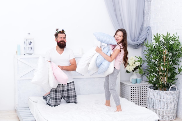 Fathers love is unconditional Bearded man and little girl enjoy playing together Happy man and small child have fun in bedroom Man and daughter relationship Fatherhood changes a man