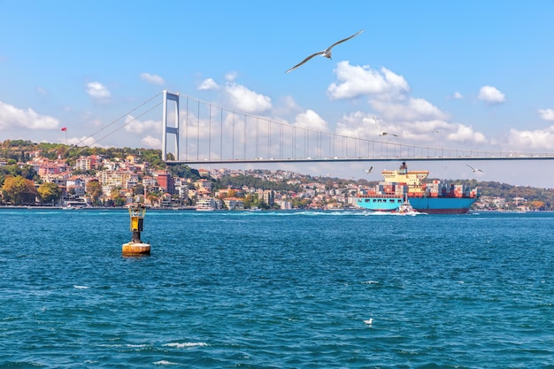 The Fatih Sultan Mehmet Bridge the cargo ship and the Bosphorus view Istanbul