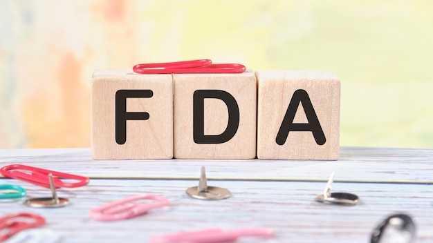 FDA text written on wooden cubes on a light colored background