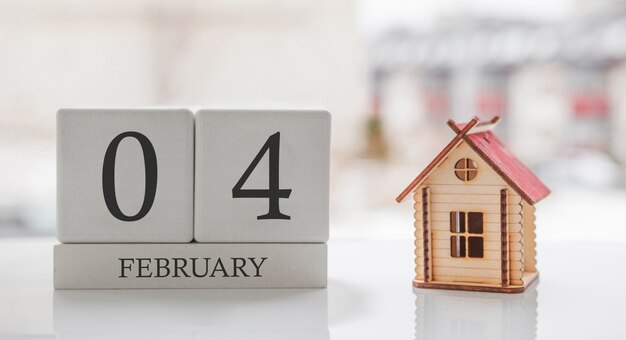 Photo february calendar and toy home. day 4 of month. card message for print or remember