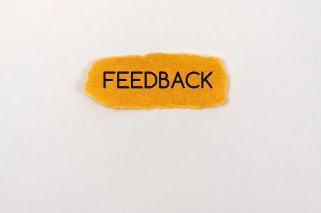 Feedback text on brown torn paper