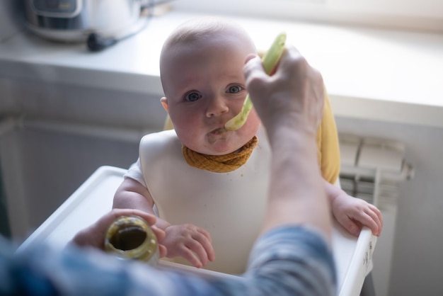 Feeding a little caucasian baby for first time