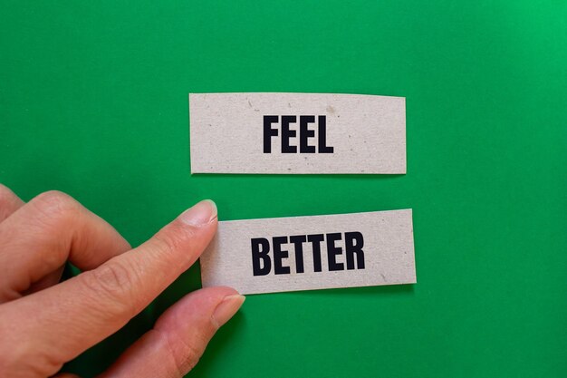 Photo feel better message written on paper pieces with green background conceptual feel better symbol copy space