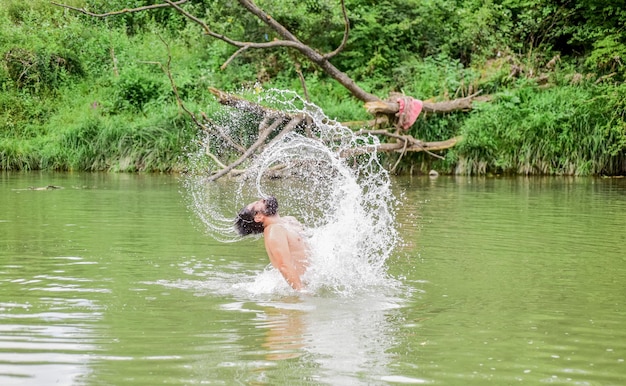 Feeling free bearded man swimming in lake summer vacation mature swimmer brutal hipster with wet beard refreshing in river water water beast furry monster wild man time to relax