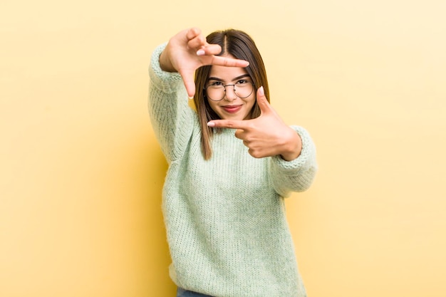 Photo feeling happy friendly and positive smiling and making a portrait or photo frame with hands