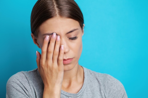 Feeling strong headache massaging temples exhausted from overwork fatigued overwhelmed lady