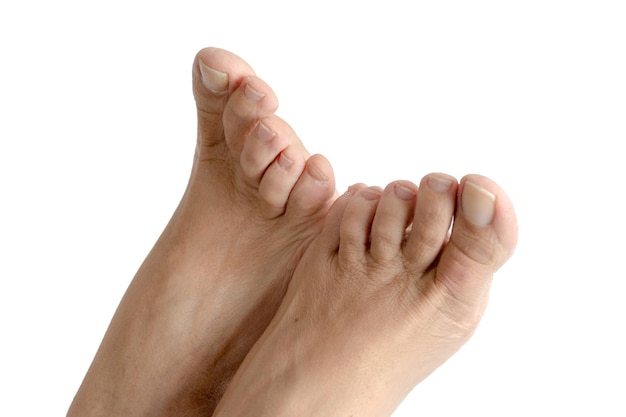 Feet of a caucasian adult woman on white background..