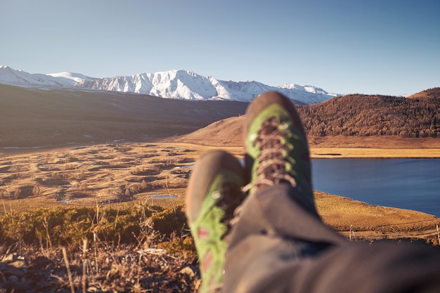 Feet Hiker relaxing enjoying view entrance outdoor. Travel Lifestyle concept adventure vacations outdoor.