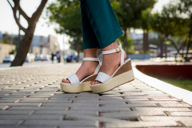 feet and legs with different types of casual and elegant shoes on various natural and urban backgrounds without brand