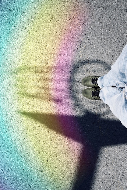 Photo feet with sneakers on the ground in the street