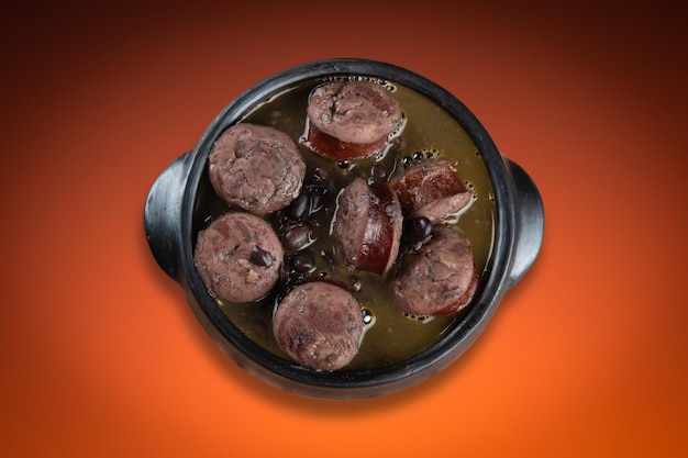 Feijoada in ceramic pot with gradient colored background