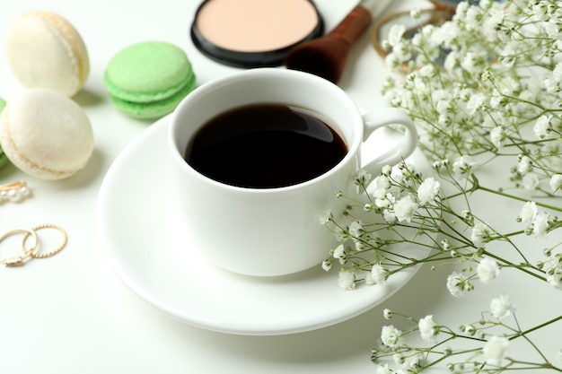 Female accessories and macaroons on white background