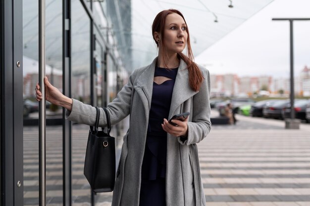 Female actuary in business clothes at the entrance to the business center