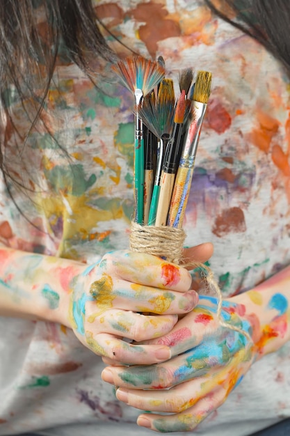 Female artist hands with paint brushes