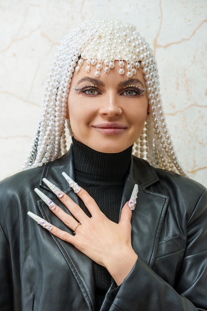 Female artist showing a hand with decorated fake nails